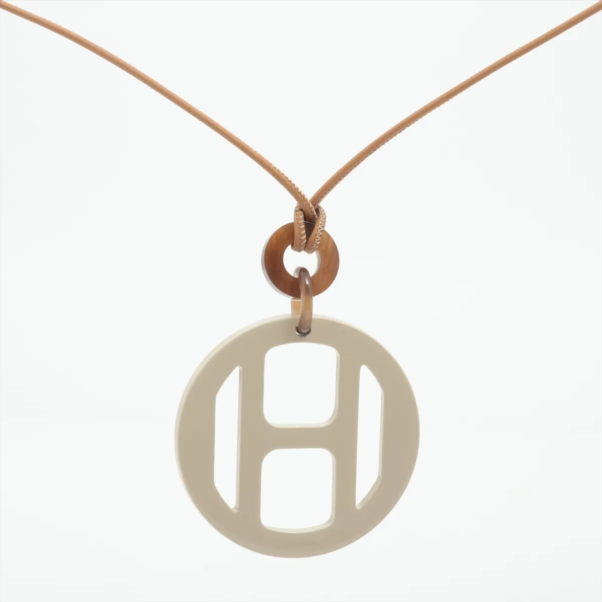 H Equipe pendant, buffalo horn x lacquered wood, some wear, tarnishing, and strap distortion. — view 2