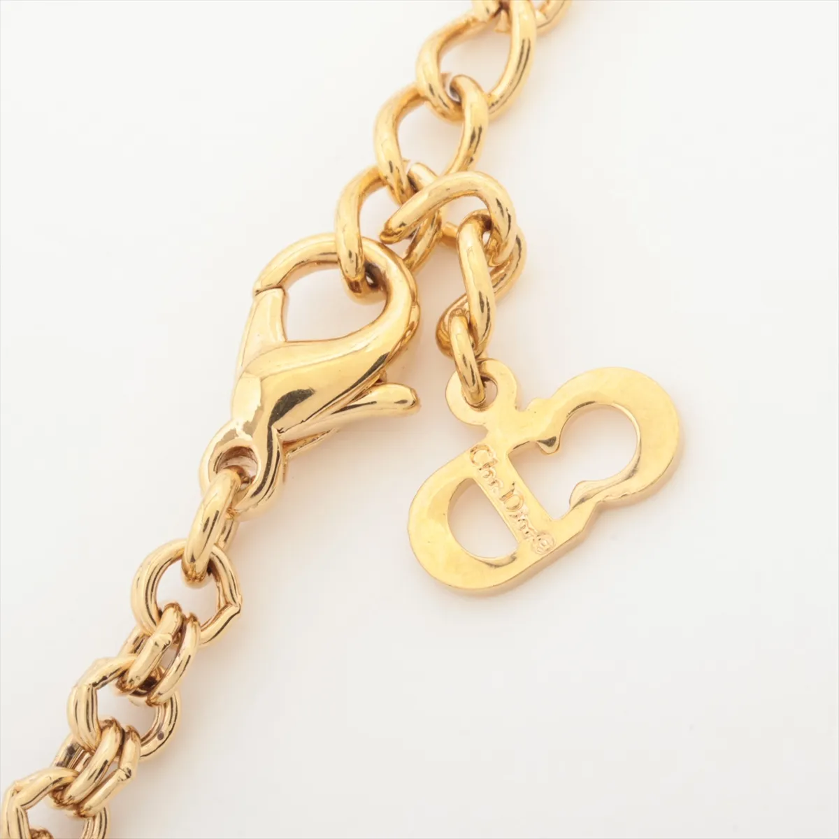 CD logo necklace, gold plated with rhinestones. Shows signs of wear, including — view 4