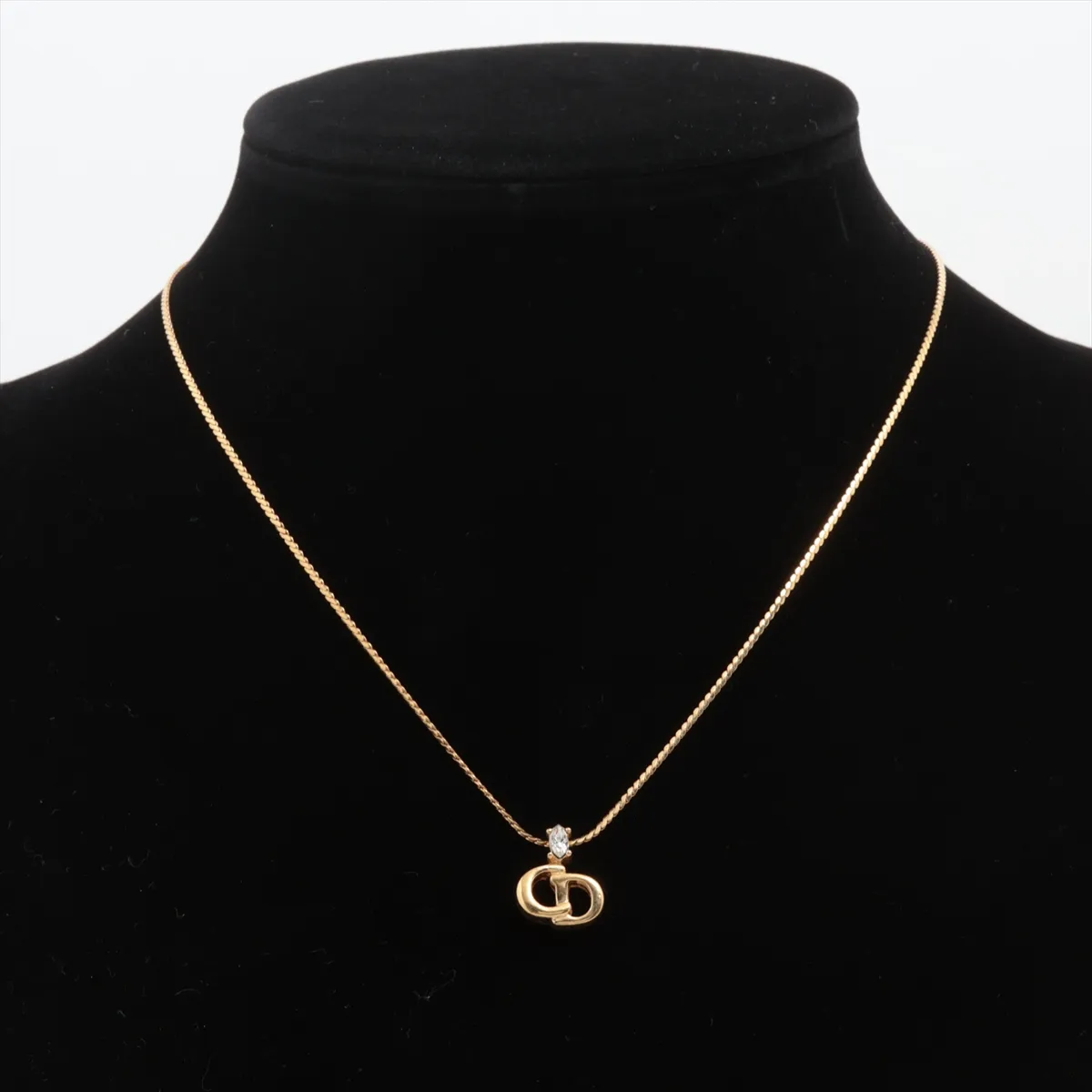 CD logo necklace, gold plated with rhinestones. Shows signs of wear, including — view 5