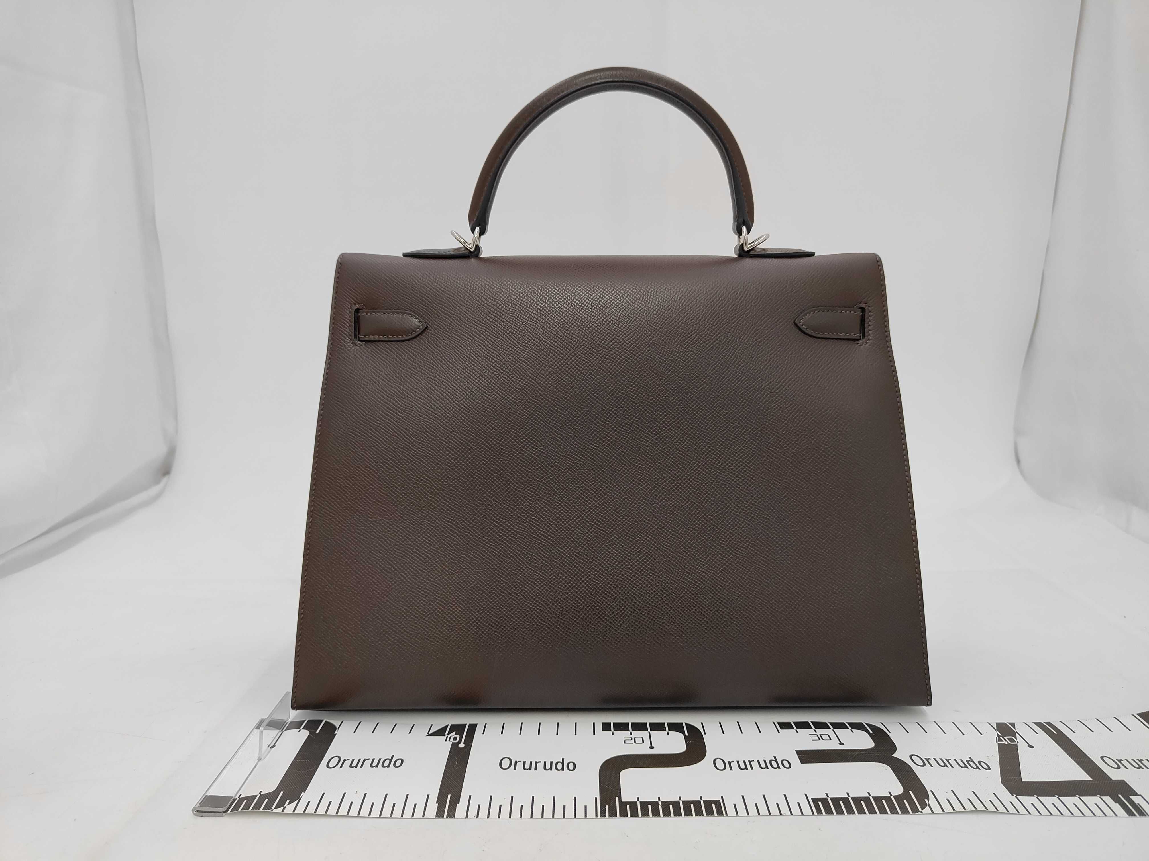 Kelly 35, 2-way bag, Epsom leather, dark brown, silver hardware, N stamp, includes dust bag, strap, rain cover, clochette, key, and 2 keys. 35x25x13cm, shoulder strap approx. 9cm. Handbag. — view 2