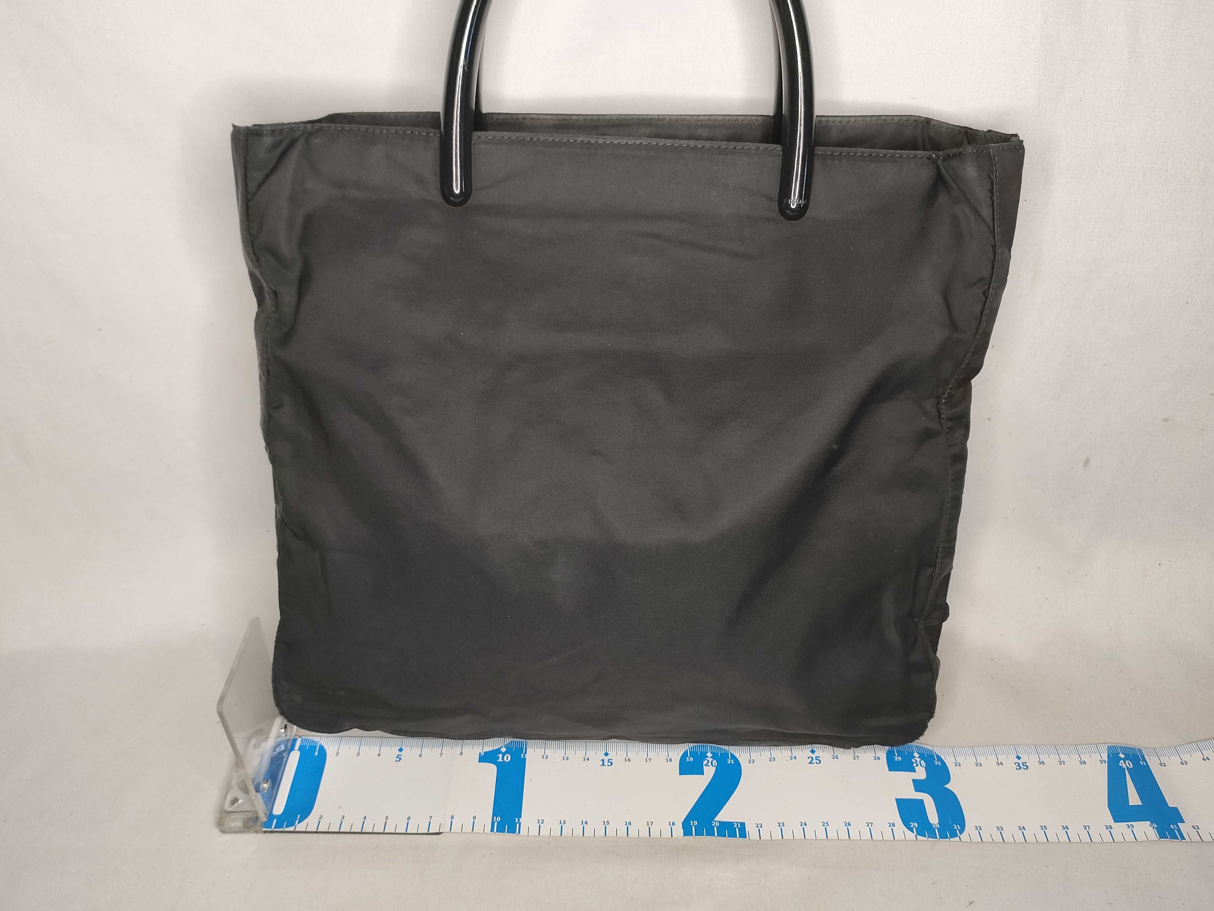 nylon handbag, black, with plastic handle and triangular plate. — view 2