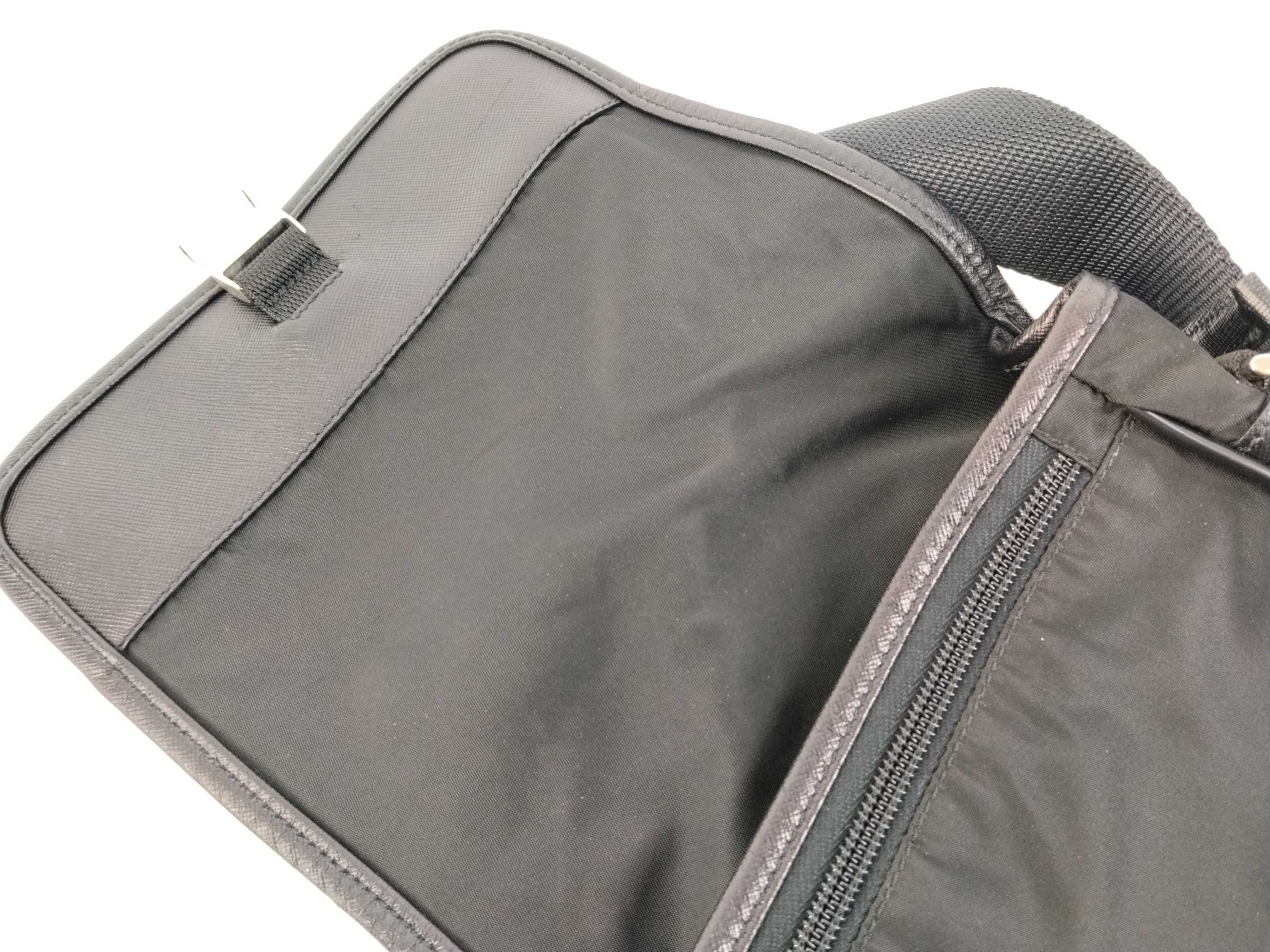 nylon shoulder bag with triangular logo plate, black nylon, white tag, and dust bag. — view 9