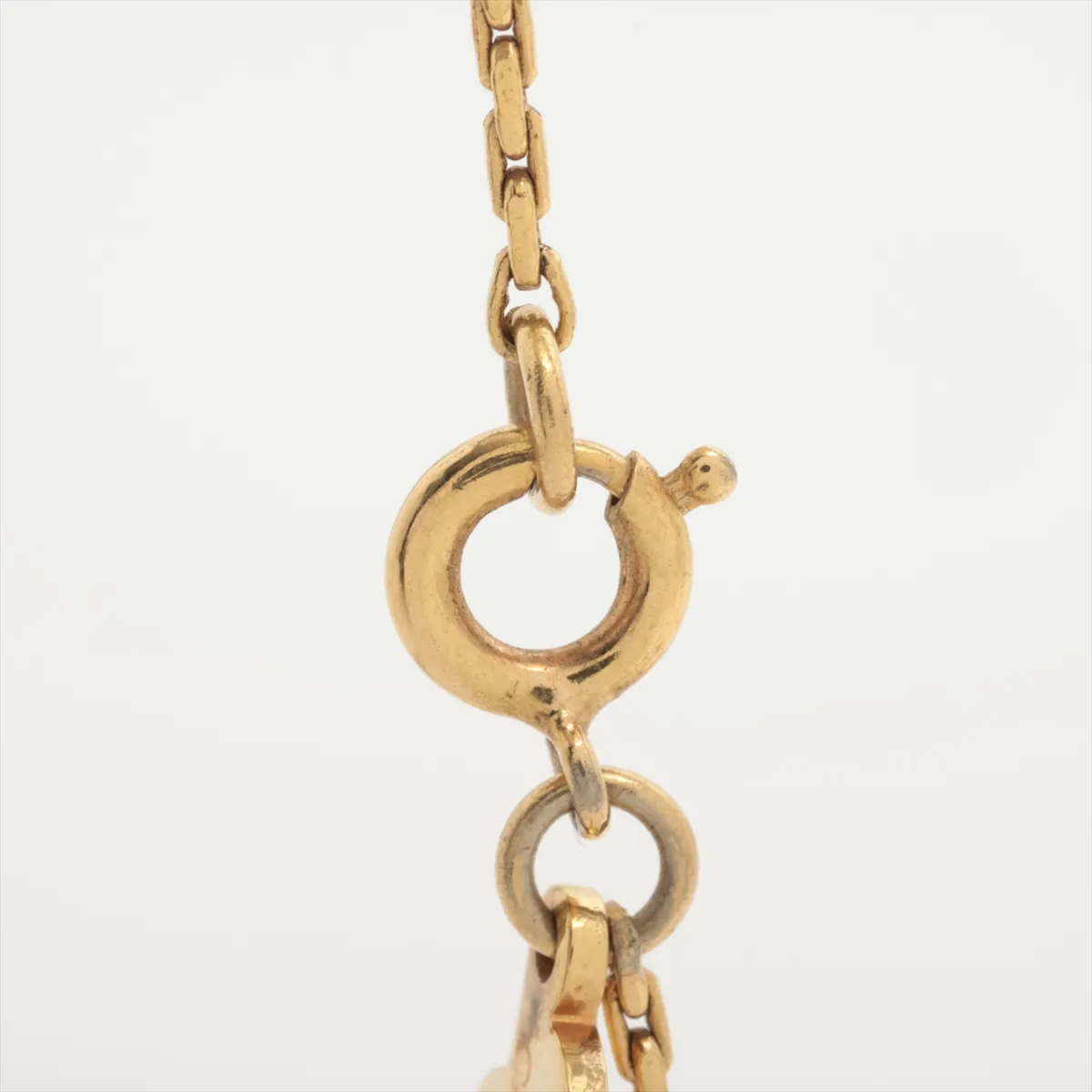 CD logo necklace, gold plated with rhinestones. Shows signs of wear, including — view 3