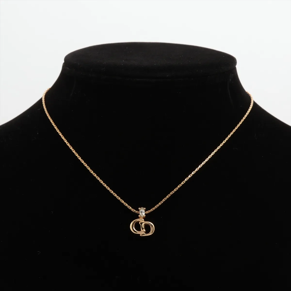 CD logo necklace, gold plated with rhinestones. Shows signs of wear, including — view 5