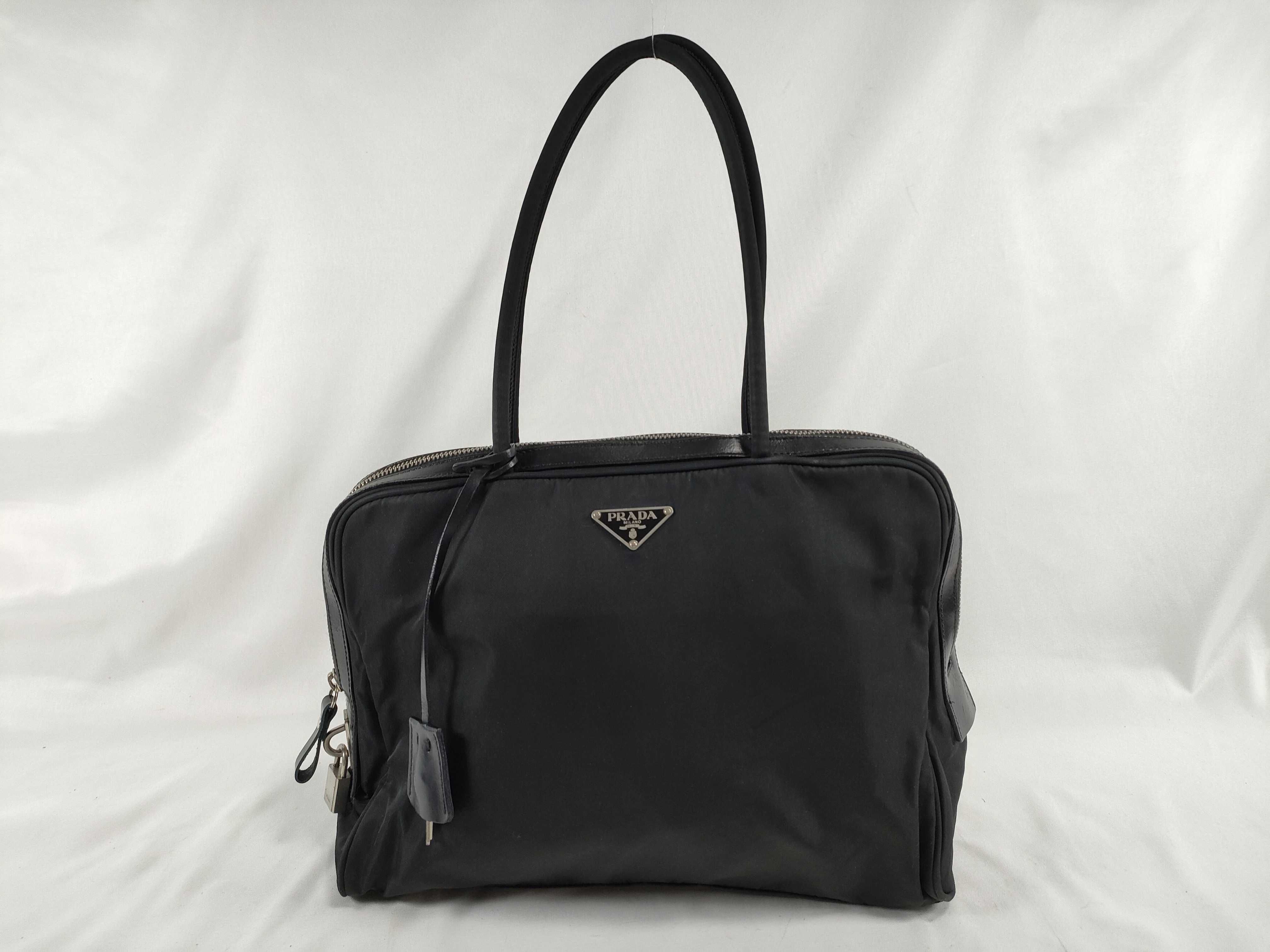 nylon leather handbag, black, serial number, padlock, key.