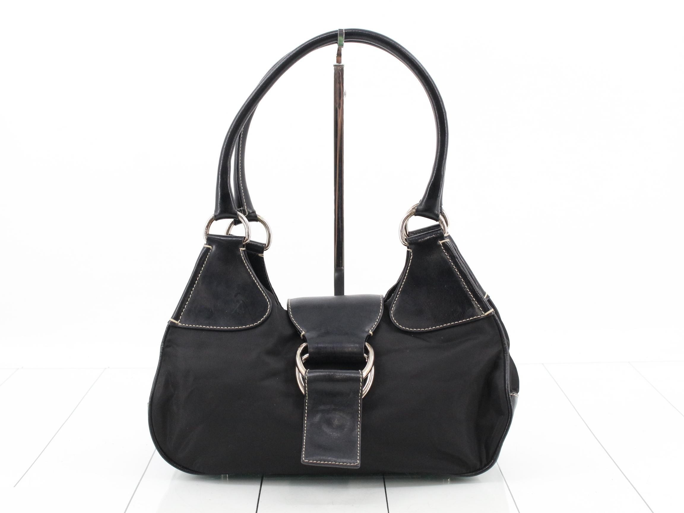 Leather and nylon shoulder bag with triangular logo.