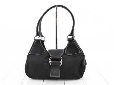 Leather and nylon shoulder bag with triangular logo.
