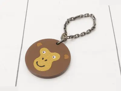 Animal charm, brown leather, metal