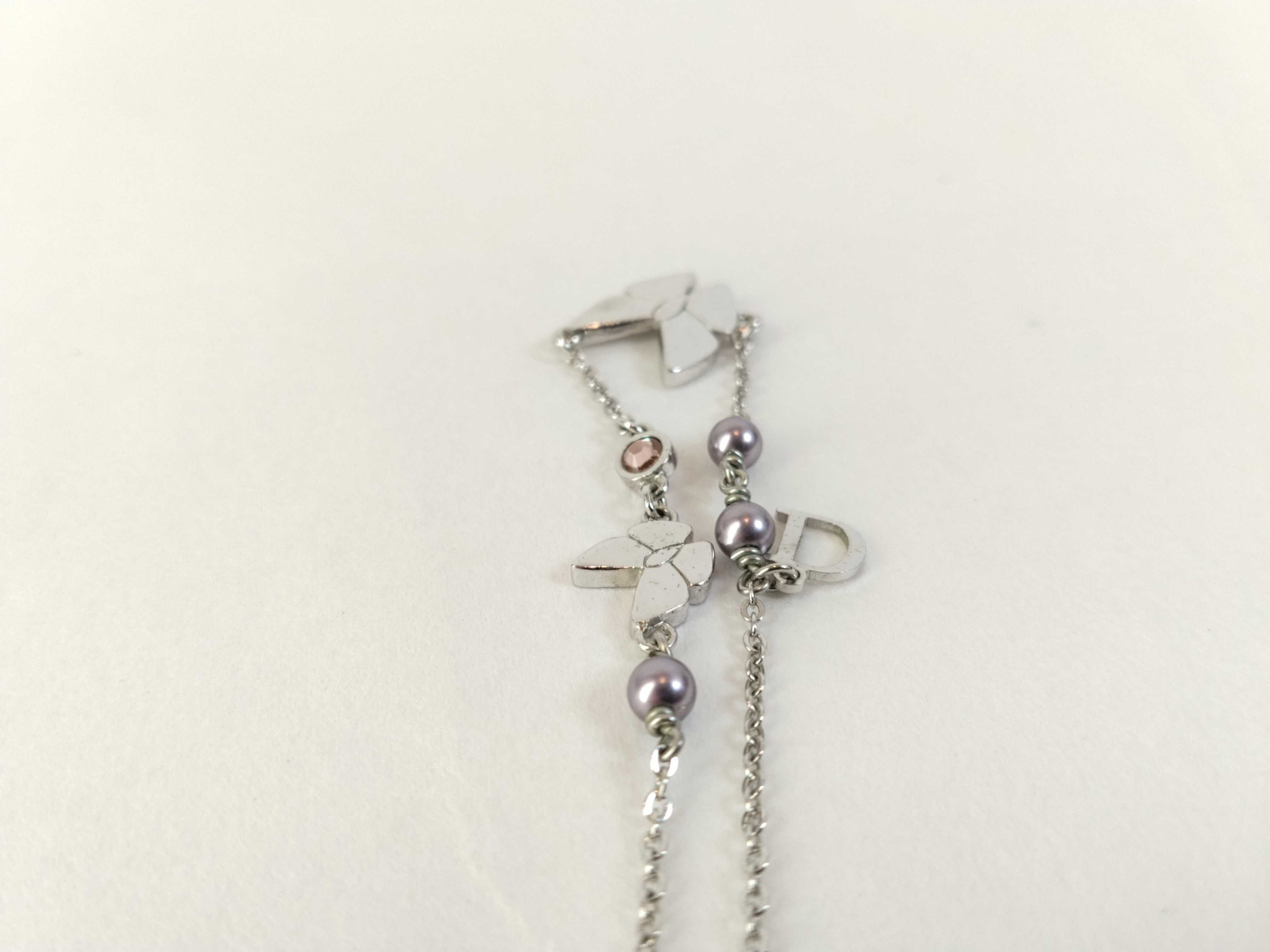 silver-colored butterfly motif necklace — view 9