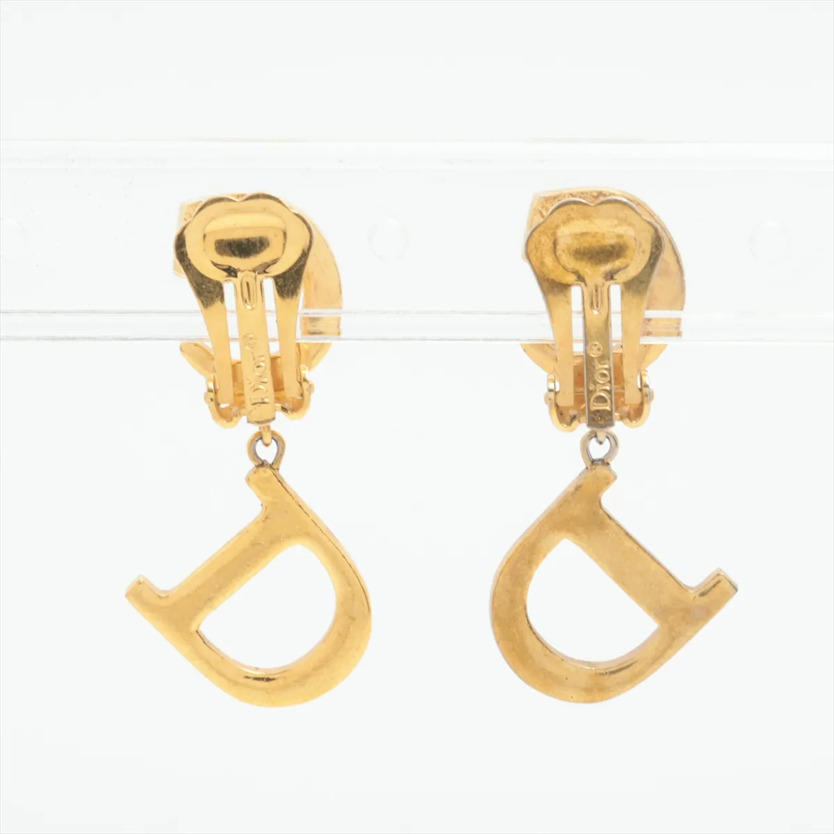 CD logo earrings (for both ears), gold-plated with rhinestones. Shows signs of wear including dents, — view 2
