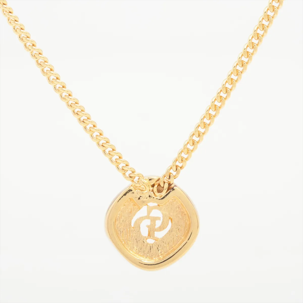 CD logo necklace, gold plated with rhinestones. Shows signs of wear, including — view 2