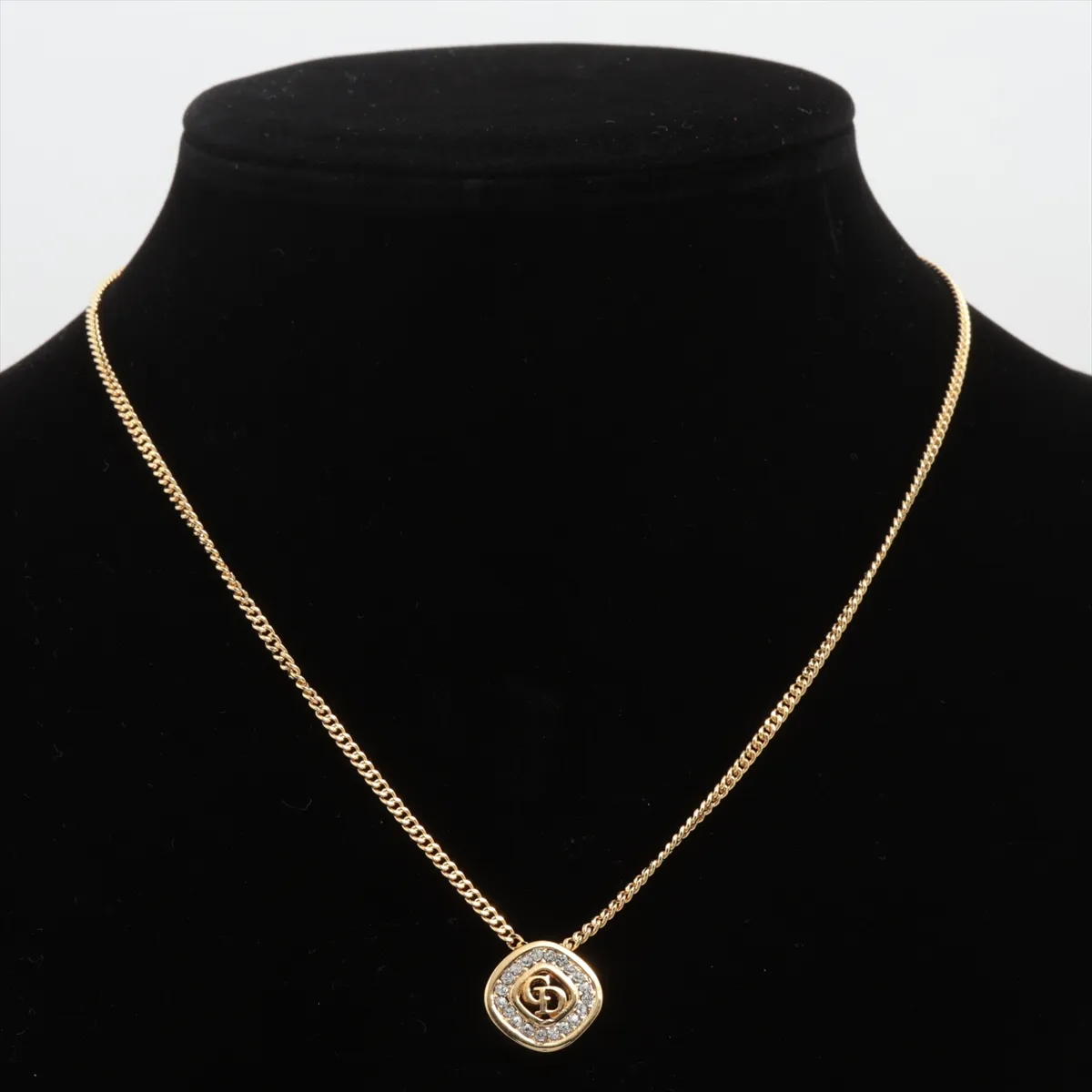 CD logo necklace, gold plated with rhinestones. Shows signs of wear, including — view 5