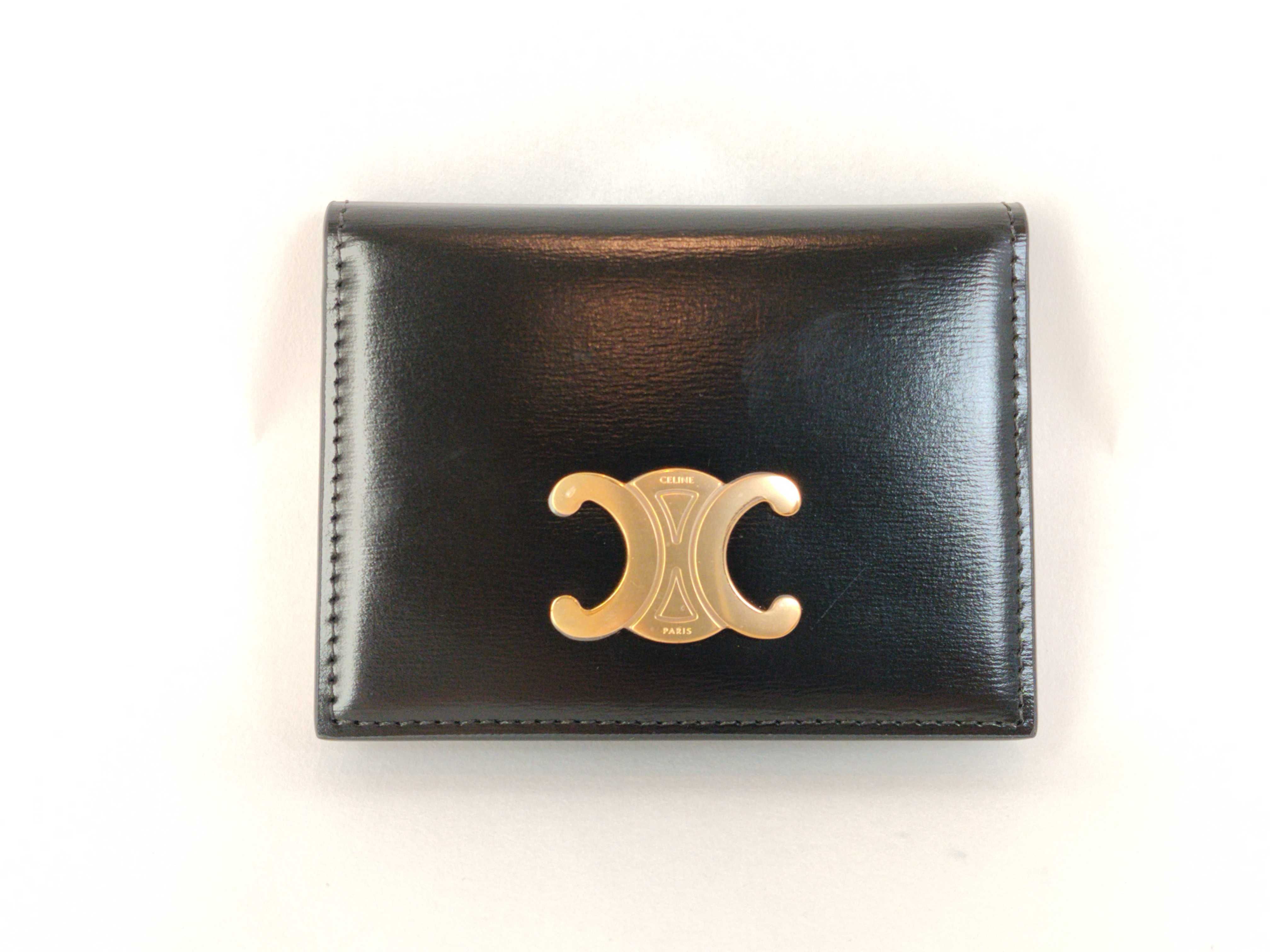 Bifold Triomphe Card Holder, Black/Gold, with protective film on hardware. Card case, pass case, business card holder.