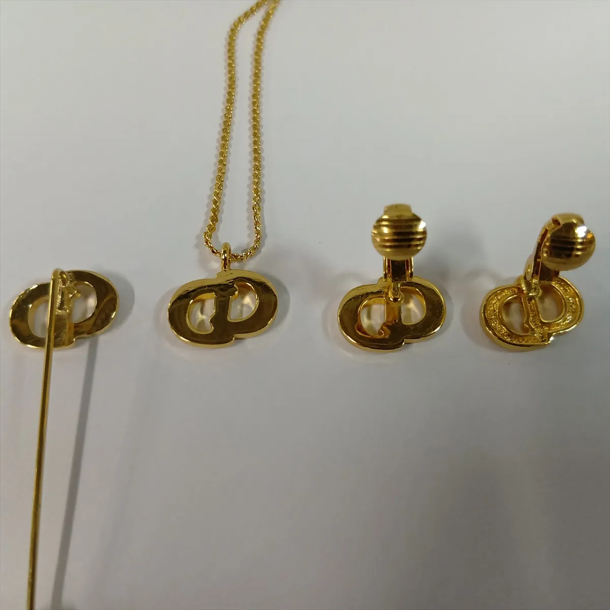 CD logo necklace, gold plated with rhinestones. Shows signs of wear, — view 15
