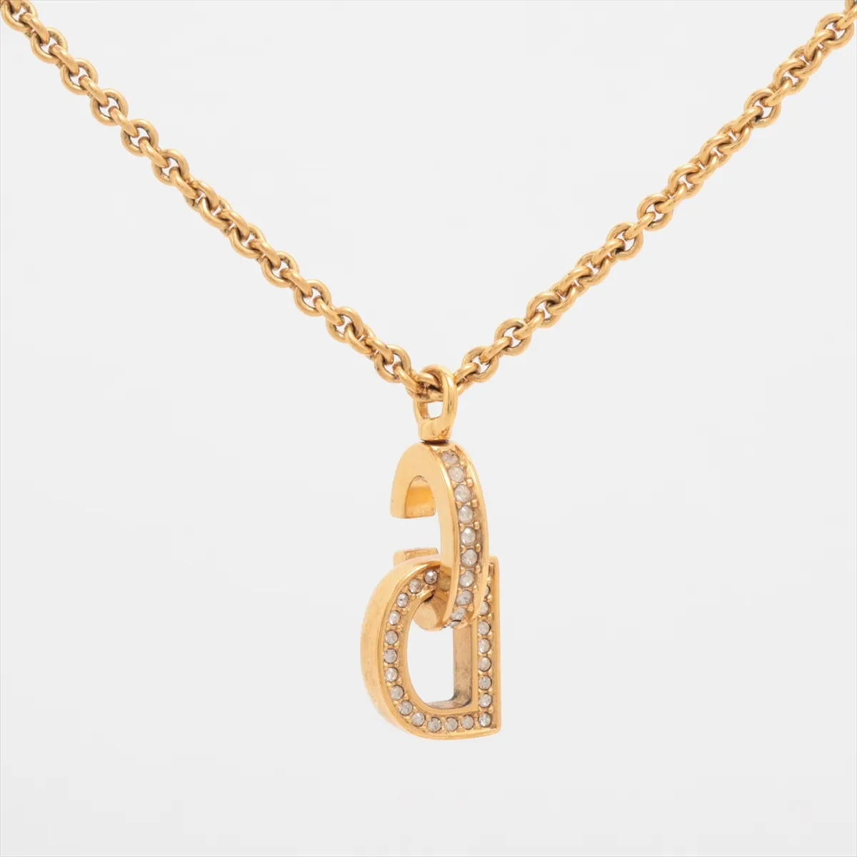 CD logo necklace, gold plated with rhinestones. Shows signs of wear, including — view 2