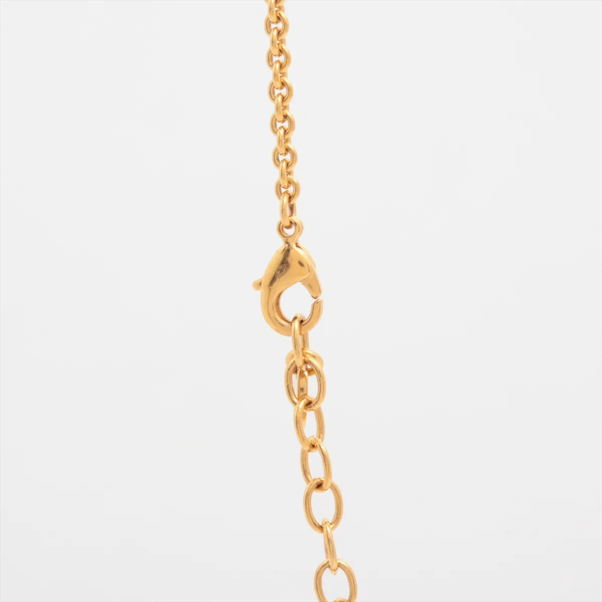 CD logo necklace, gold plated with rhinestones. Shows signs of wear, including — view 3