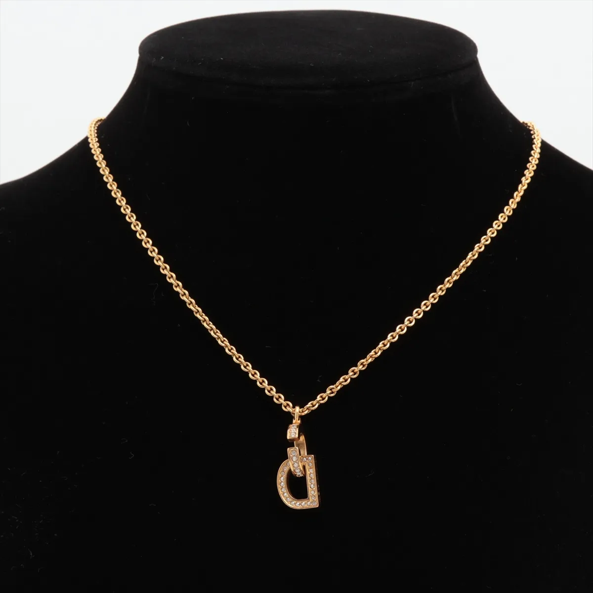 CD logo necklace, gold plated with rhinestones. Shows signs of wear, including — view 5