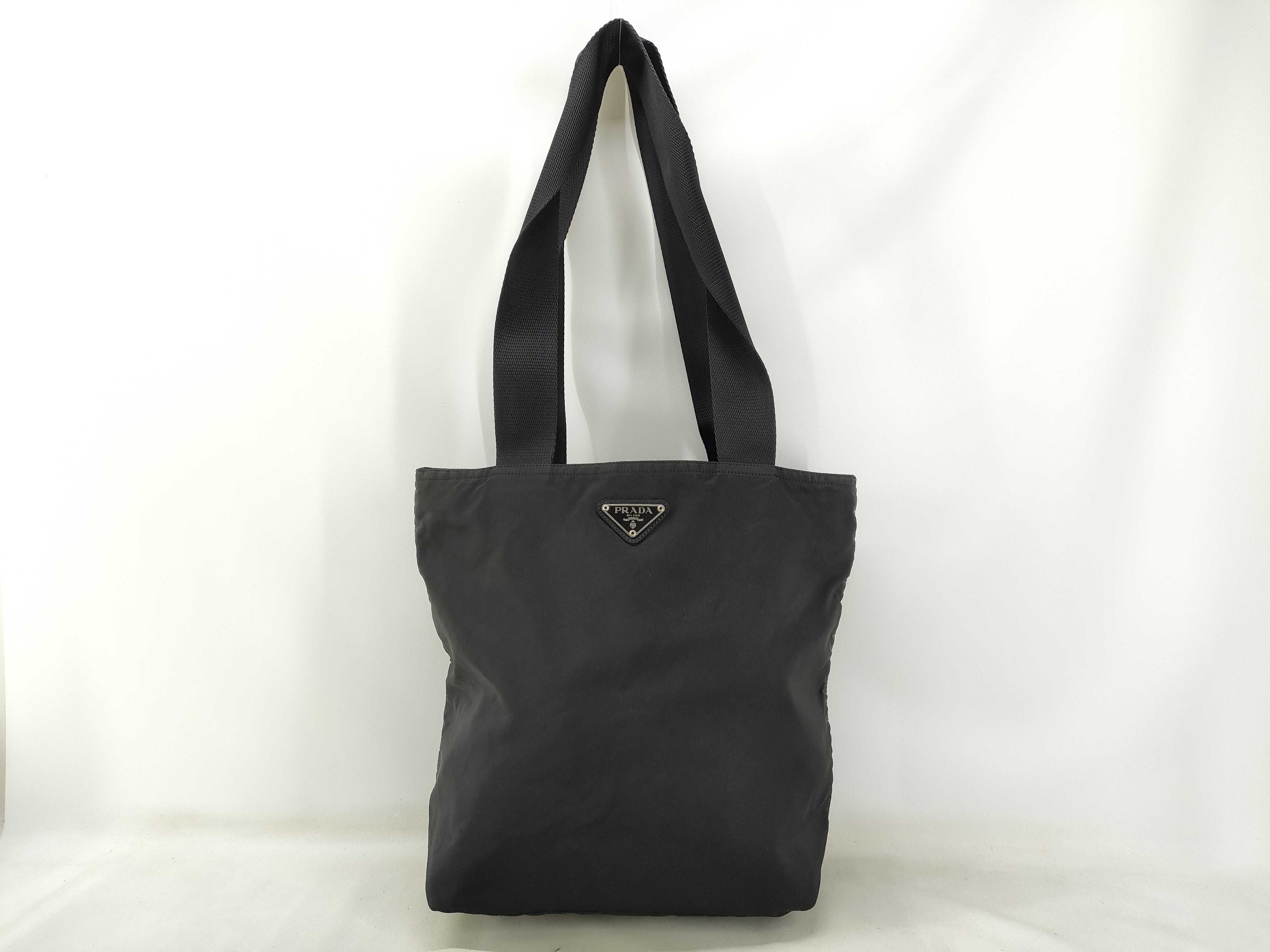 nylon tote bag, black, with zipper and white tag, size 25.