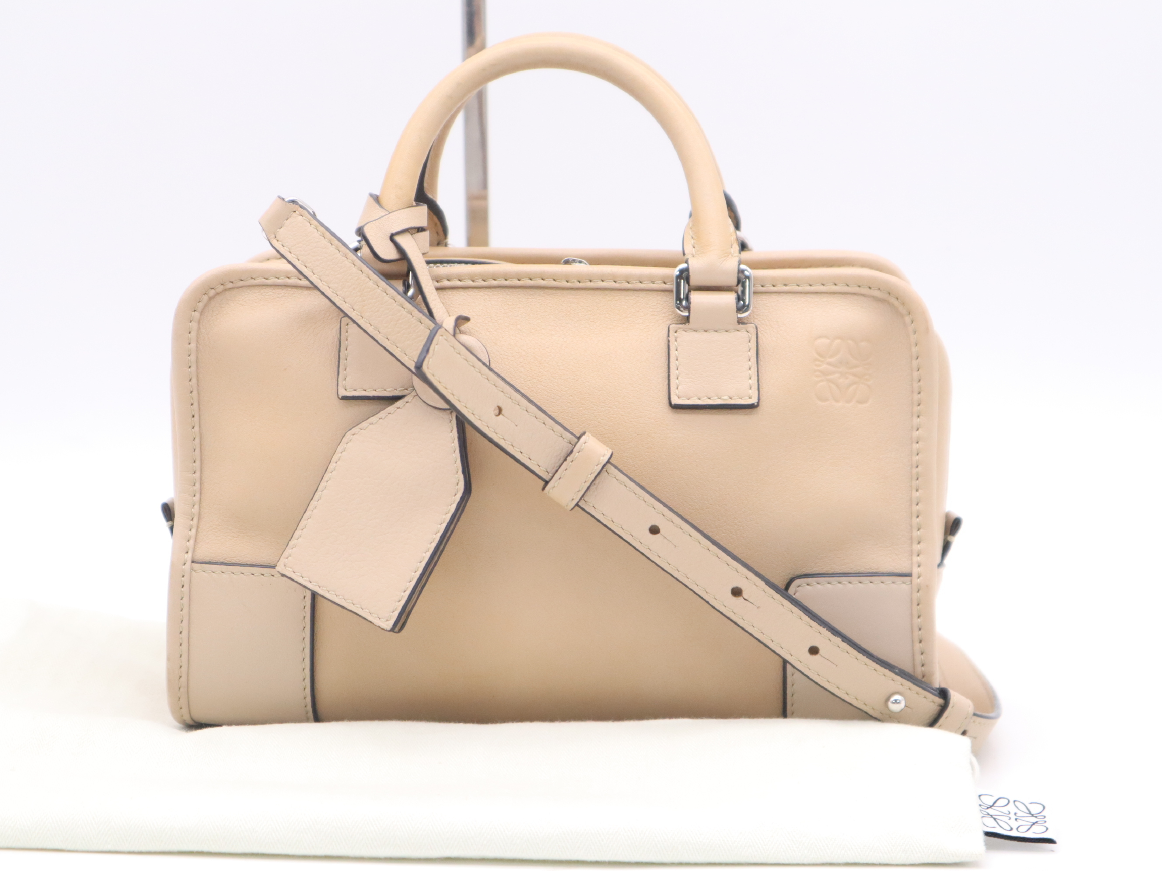 Leather Amazona 23 Handbag, Beige, Silver Hardware, with Shoulder Strap, Charm, and Dust Bag.