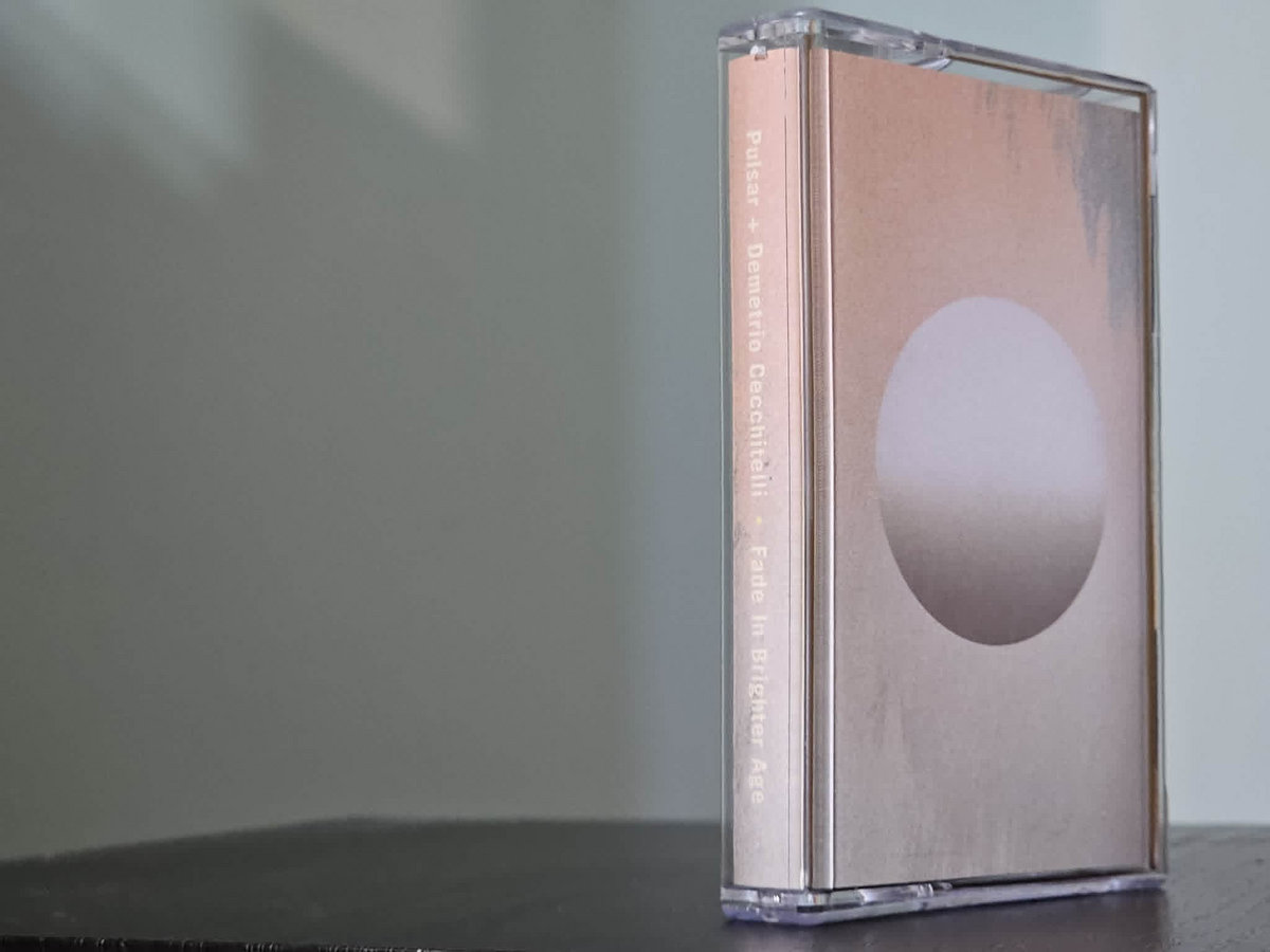Edición en casete de Fade In Brighter Age de Pulsar y Demetrio Cecchitelli sobre una mesa.