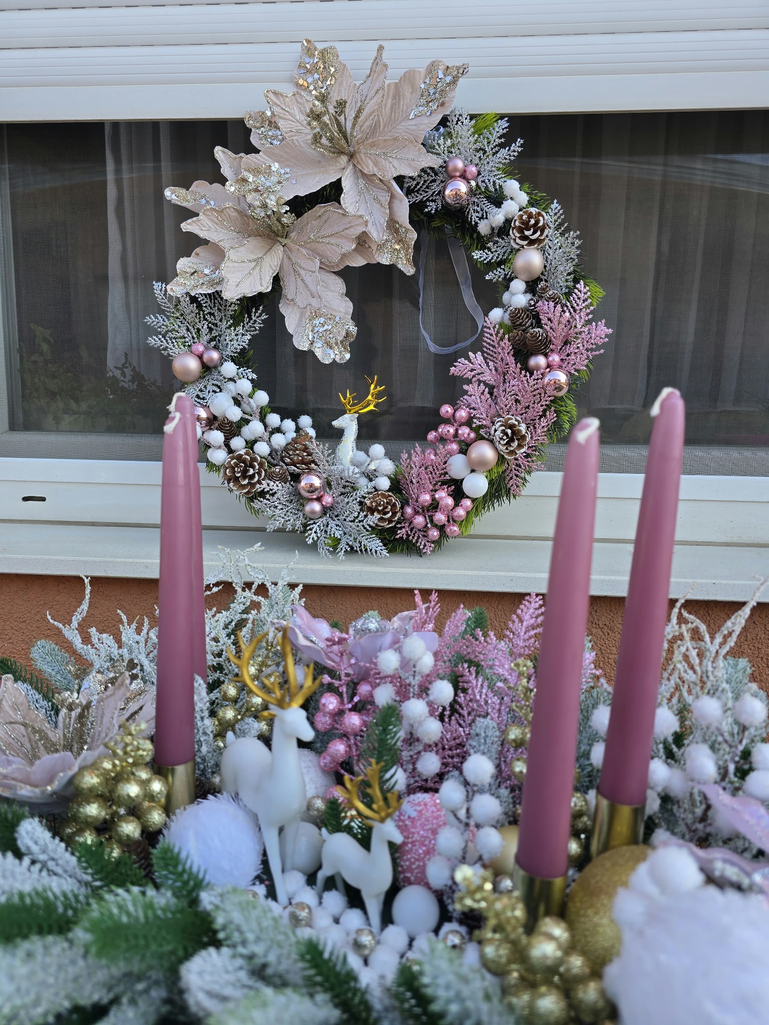 Pink Christmas door wreath with a white deer and magnolias