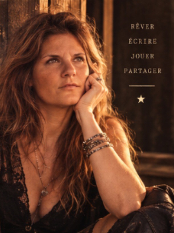 Black and white film portrait of a woman songwriter in her thirties, tobacco-brown leather jacket, hair loose, looking away from camera, hard side light through