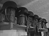 Helmets and gas masks on a shelf.