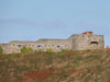 Gun loopholes and ports up the outer wall.