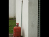 Behind the old gas cylinder is the original door hook to hold the door open.