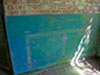 Marks on the wall show where a food bench was placed. What looks like a crane, is to lift hot pots on and off the stove..