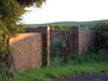 Fuel store at RAF Ringstead, Dorset. A low wall and a wire mesh fence toped with barbed wire and a steel angle iron gate with mesh and also topped with barbed wire. Security of coal stocks was greater than any other in the services.