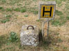 By the hydrants is an aircraft tie down concrete block.
