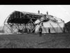 Bessonneau tented hangar being assembled. A wooden frame with a canvas cover.