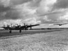 Halifax and a Horsa glider about to rotate off the end of the runway.