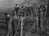 RAF personnel laying barbed wire.