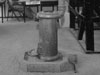 Pot bellied stove on a concrete base.