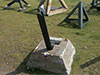 Concrete block with a mine inside. The arm is hit by a craft and the mine activated. BOOOM!