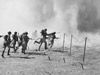 Infantry advance through the blown barbed wire.