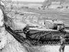 The British came up with a Churchill Tank with a frame at the front. Driving up to the wall and leaving a large amount explosives to blow through the wall. It was not used on D-Day.