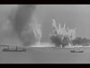 A convoy passing through the straights of Dover being shelled by long range heavy batteries.