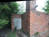 Boiler house entrance and smaller chimney.
