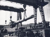 Towering cranes to lower the guns into place.