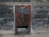A tin shuttered air vent inside in the outer wall.