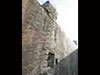Escape hatch and steel ladders running up the side of a bunker.
