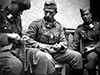 Machine gunners linking up belts.
