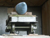 Narrow gauge railway truck carnying a large shell.