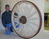 A wooden wagon wheel with a steel tyre fitted over the wood.
