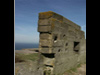The bunker and it looks very damaged. Its made in Formstien, a concrete block that locks into the next, the inner & outer walls are built and then filled with concrete to make the bunker.