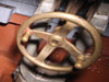 Hand operated brass wheel to lower and higher the gun. Left and right would have been by just moving the gun from side to side.