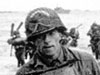The white mark on his helmet means he is part of the Beach Party. His job would be to help organise the beach head.